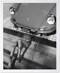 Poster Master Woman Under Classic Car Poster by PosterMaster